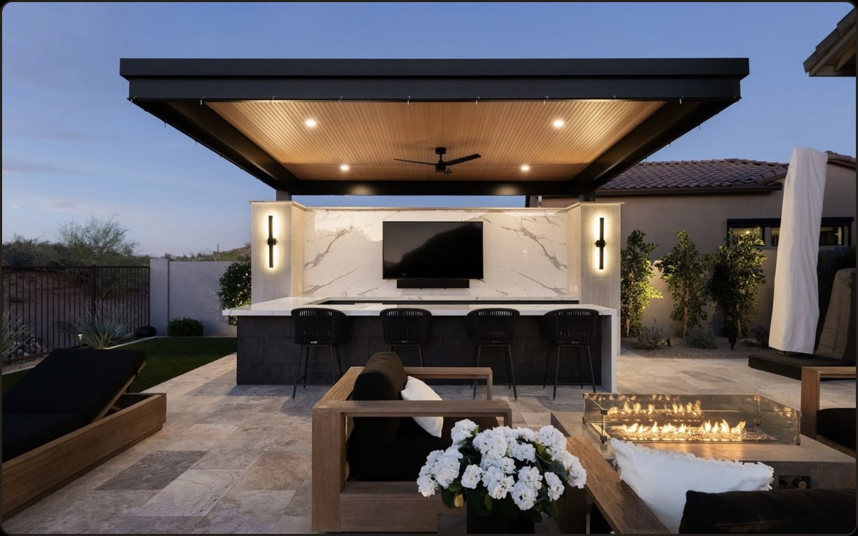 Modern cantilever pergola over an outdoor bar with integrated lighting and a fire feature